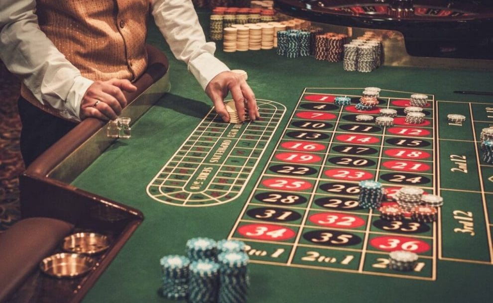 A croupier handling casino chips on a roulette