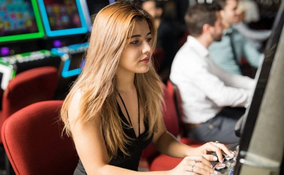 A person playing at a slot machine.