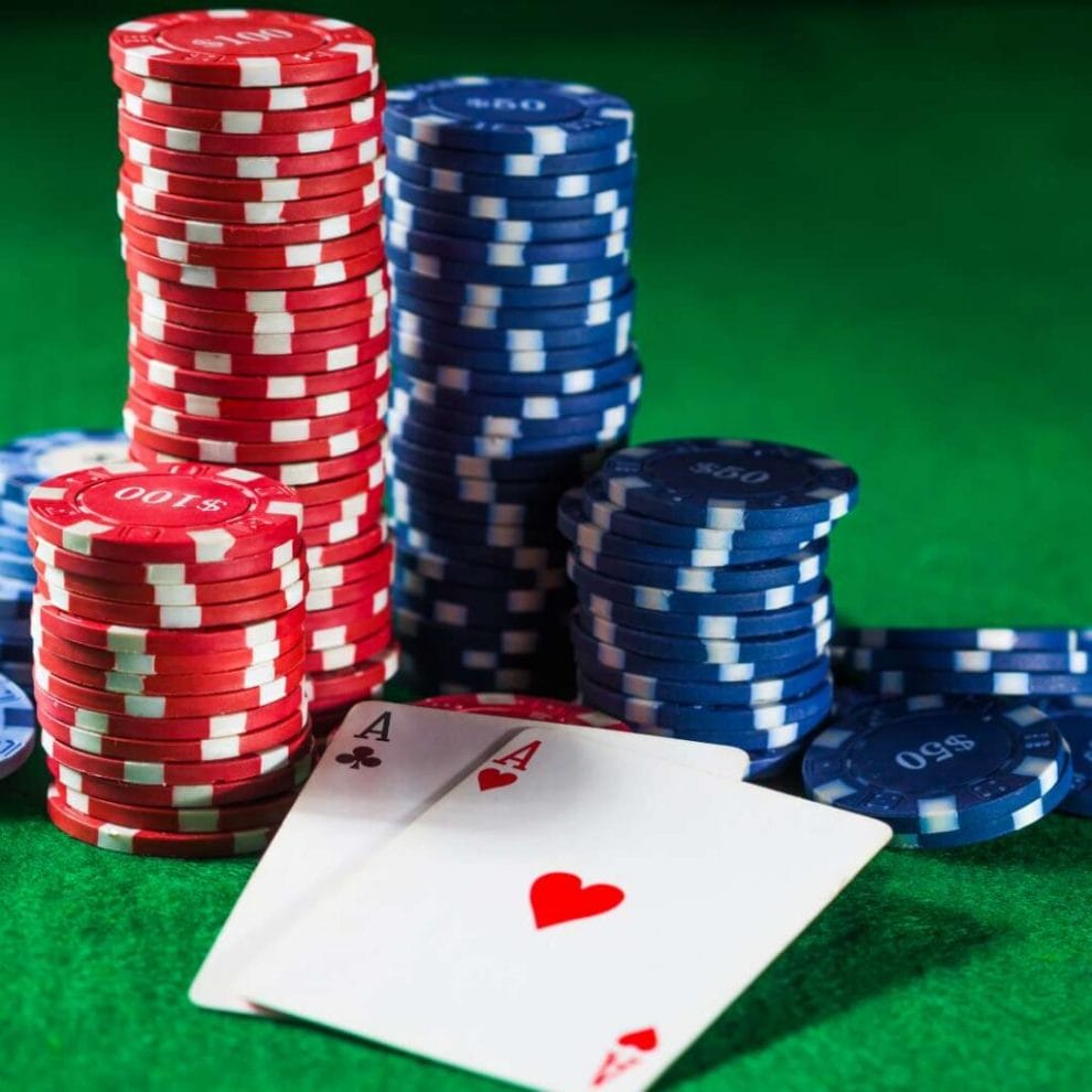 Poker cards and casino chips on a green felt table.