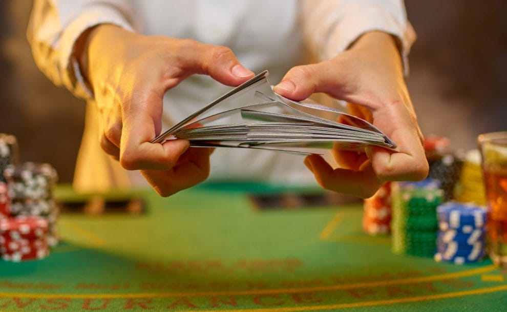 A poke dealer shuffling playing cards.