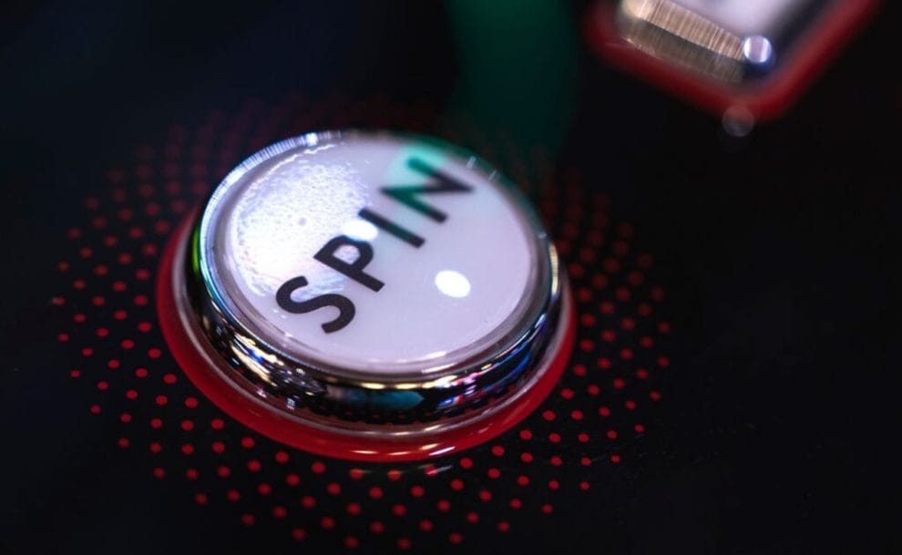 A closeup of the “spin” button on a slot machine at a casino.