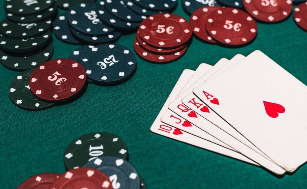 Poker chips and playing cards arranged on a table.