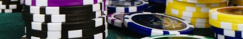 Small stacks of poker chips on a dark green felt table.