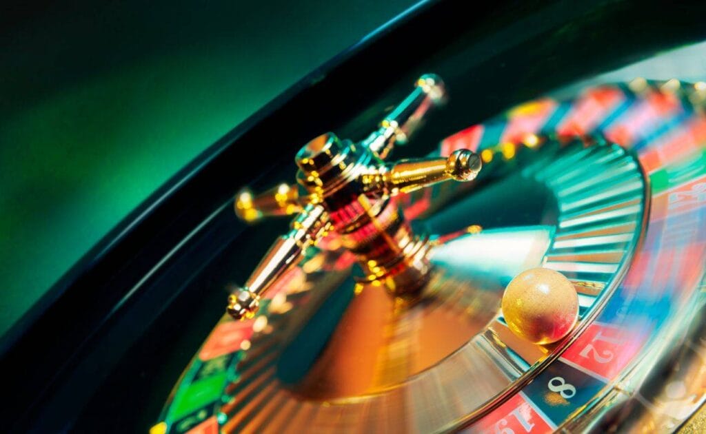a little white roulette ball has landed on the red number 12 in a roulette wheel that is still spinning