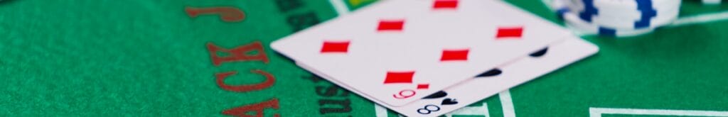 Blackjack cards on a green felt table.