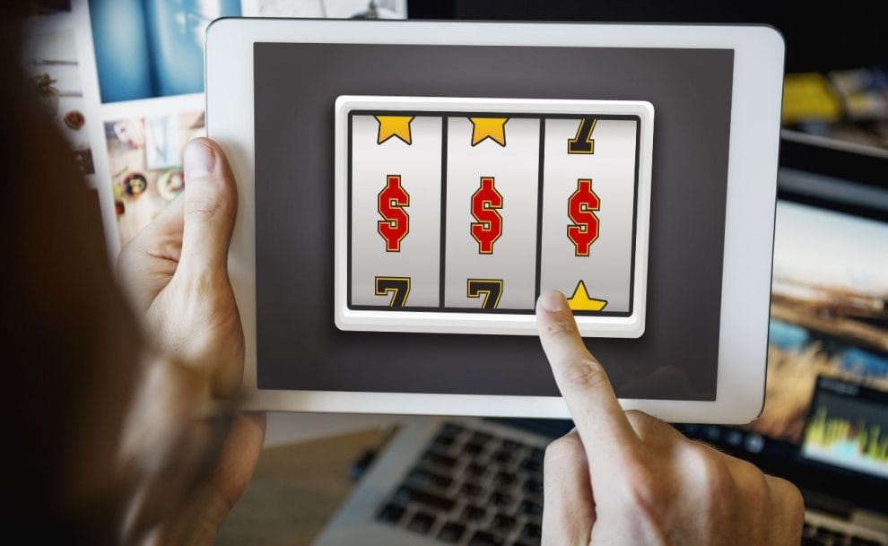 A person playing an online slot game on a tablet. 