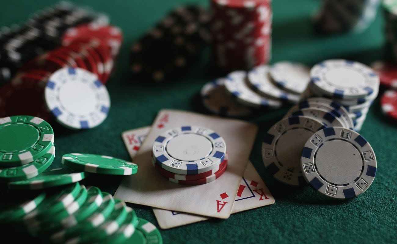 Poker chips and playing cards arranged on a poker table.