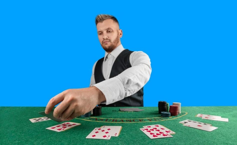 A blackjack dealer placing cards on a green felt table.