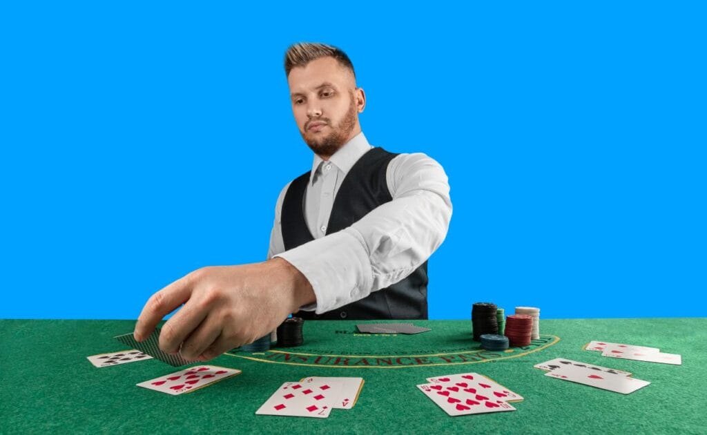 A blackjack dealer placing cards on a green felt table.