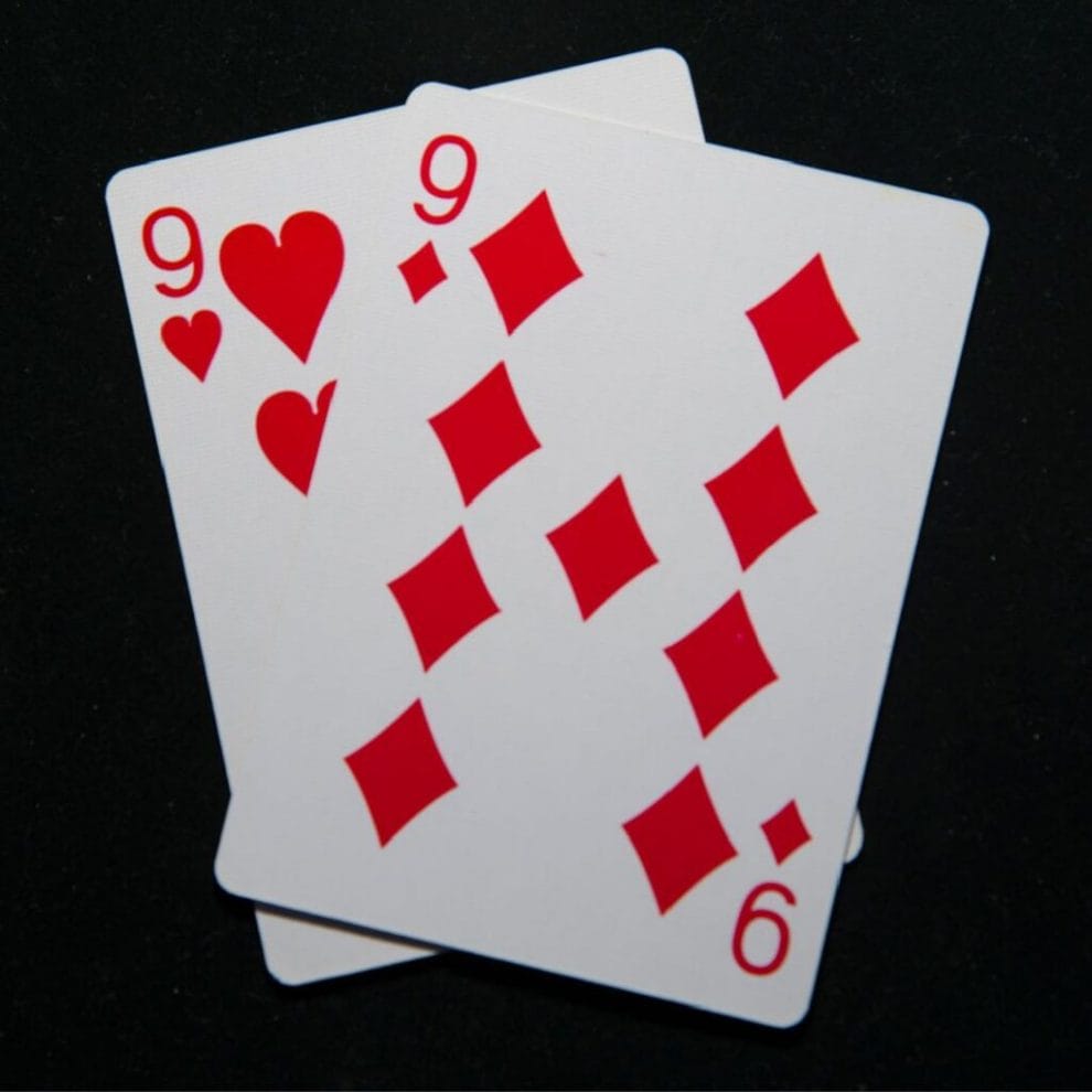 Two nine playing cards on a black background