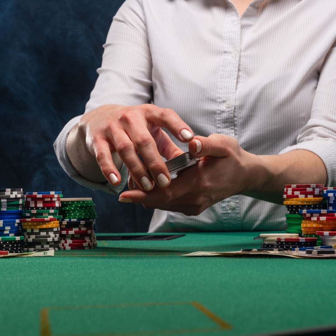 A croupier shuffles cards at a blackjack table