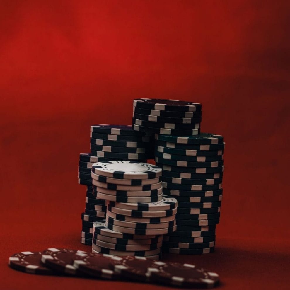 A stack of white, red, and black poker chips.