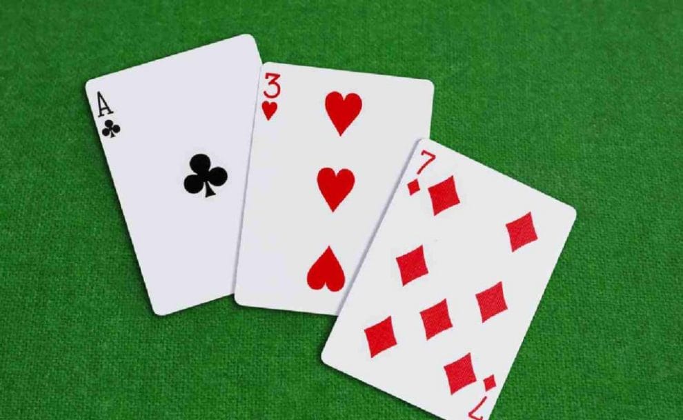 Ace, three and seven card on a green background