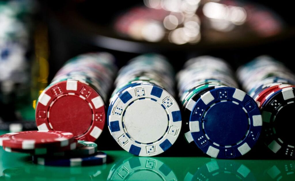 Casino chips on a green table.