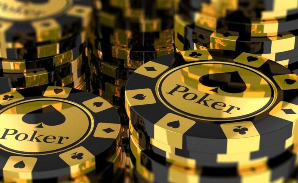 An extreme closeup of stacks of black and gold poker chips.
