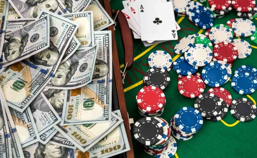 Dollar bills in a wooden box with poker chips on the right