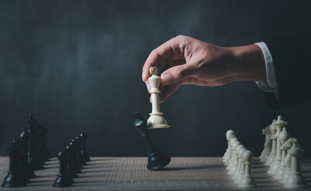 A hand moving a chess piece.