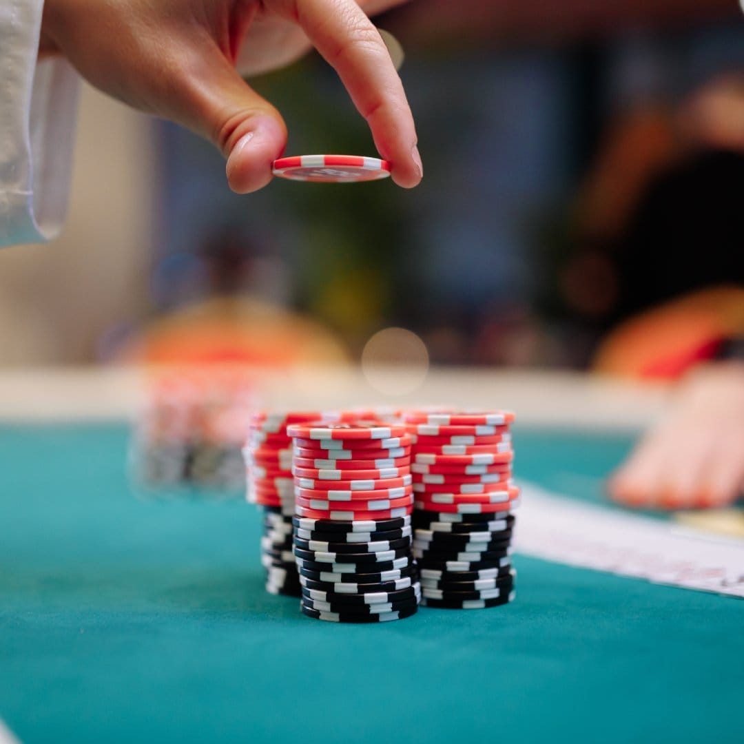 Casino chips and playing cards on a poker table.