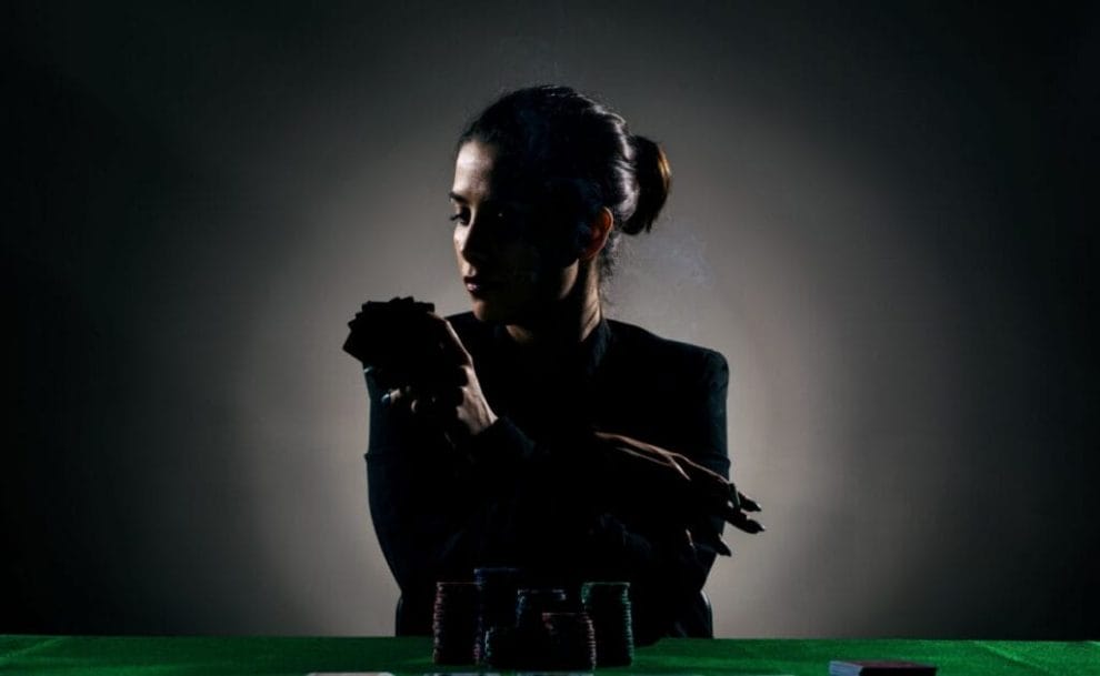 A silhouette of a person playing poker.