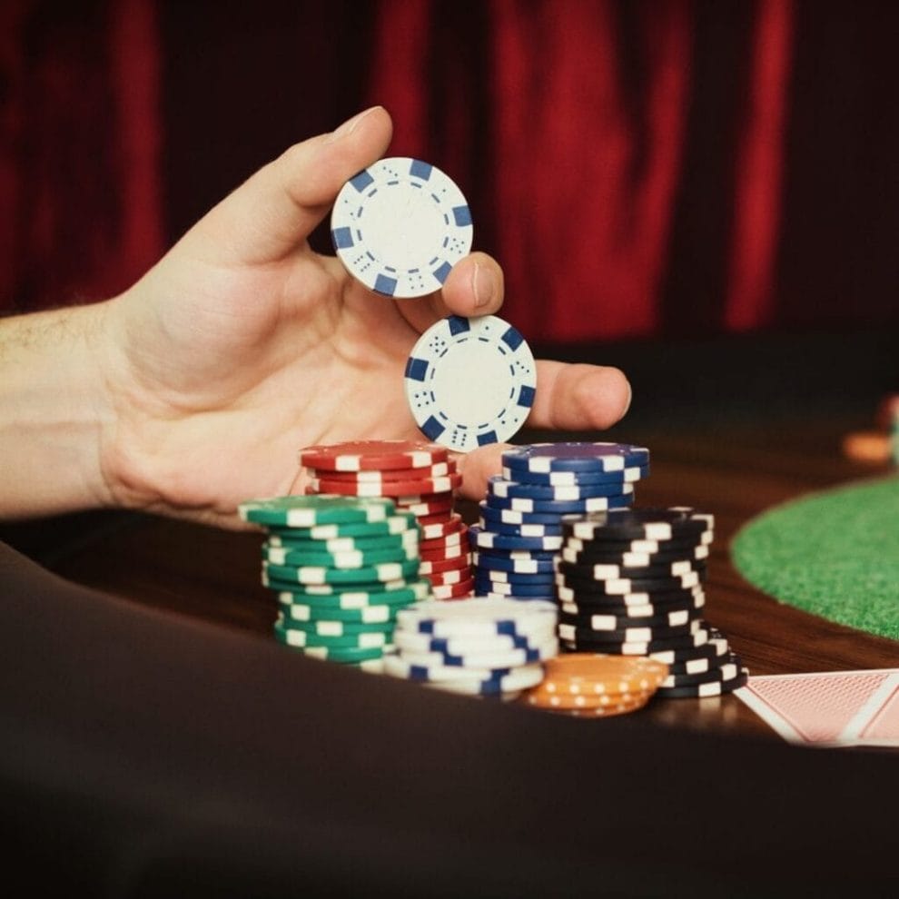 A hand holds poker chips