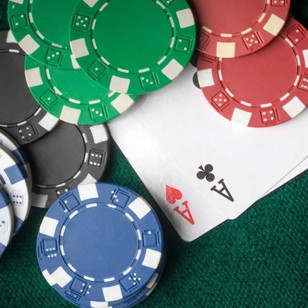 Casino chips and playing cards scattered on a casino table.
