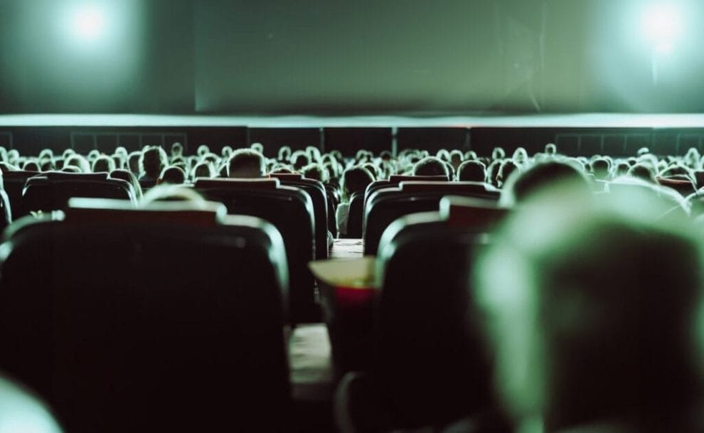 A view of a packed cinema from a cinema seat.