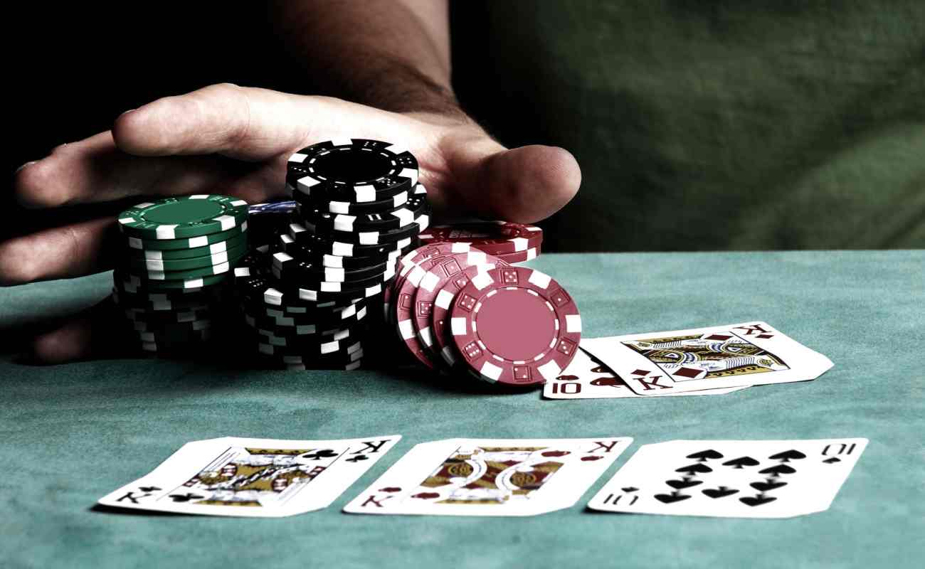 A player pushes a stack of chips on the pocker table