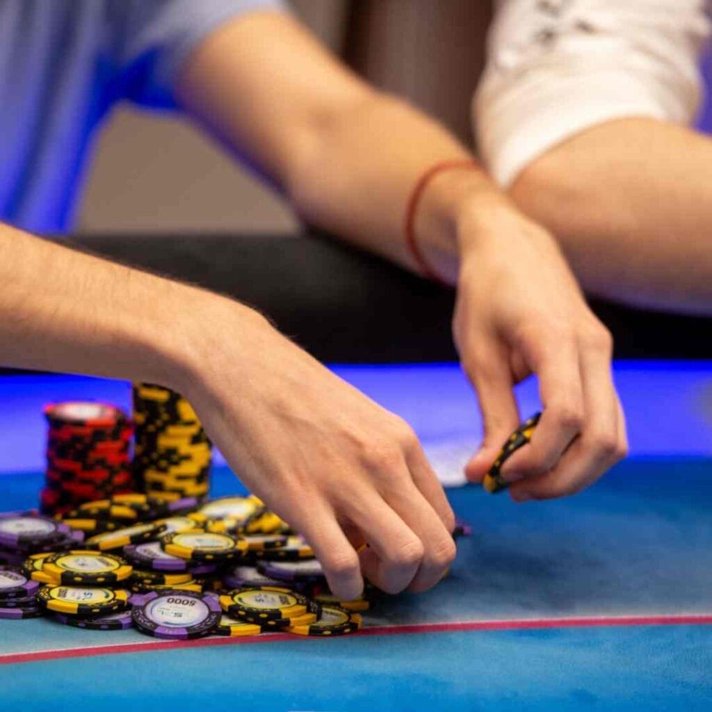 A player putting chips down on a poker table