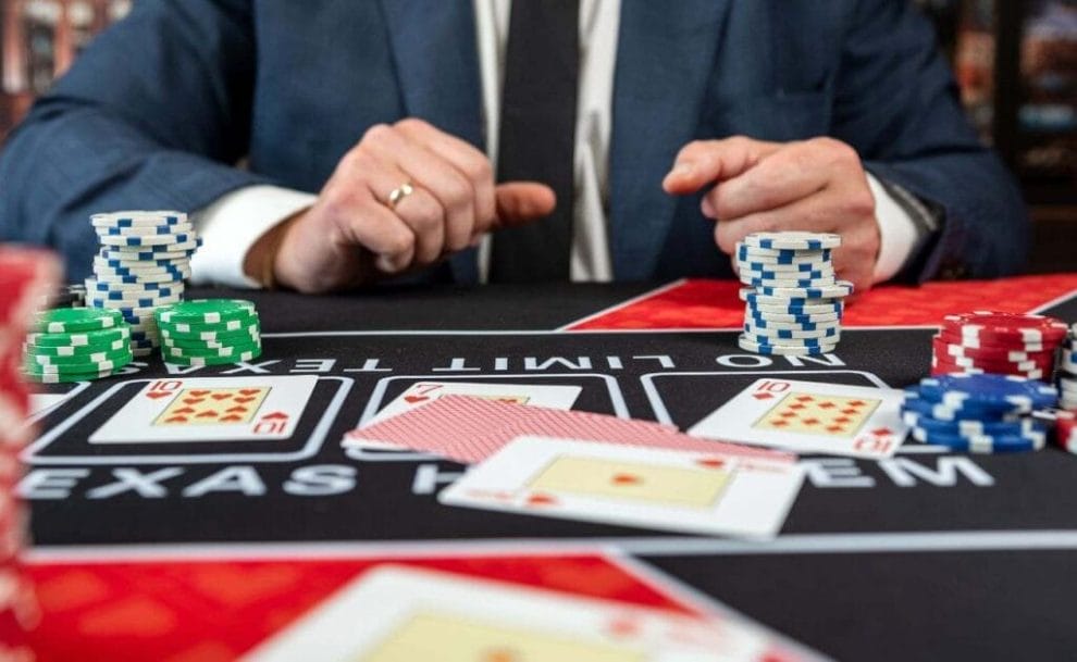 a person is sitting at a poker table with playing cards and poker chips on it in a casino 
