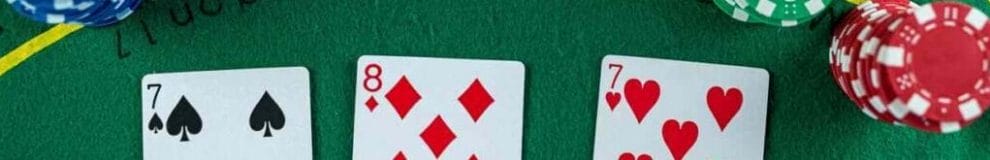 Poker cards with three of a kind or set combination.