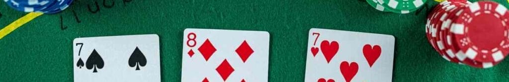 Poker cards with three of a kind or set combination.