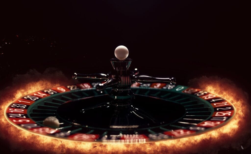 A roulette wheel outlined by fire against a black background.