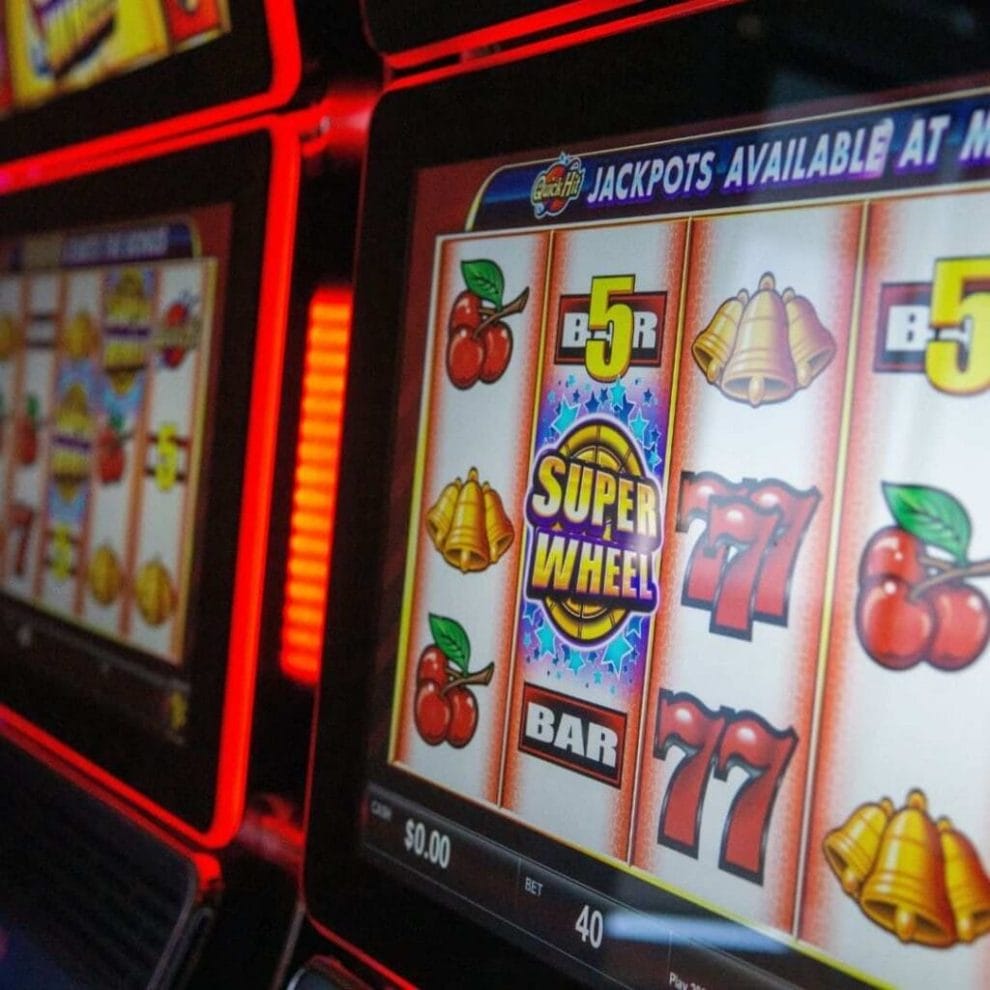 A slot machine screen, displaying traditional slot machine symbols in a casino.