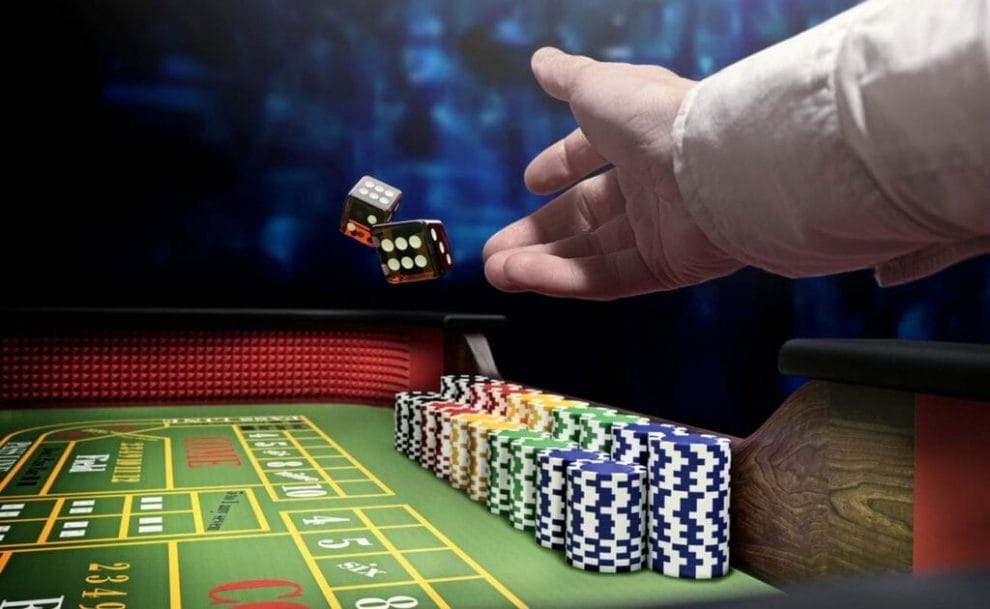 A croupier throws dice onto a blackjack table