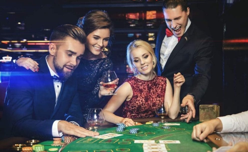 Group of young people playing poker in the casino