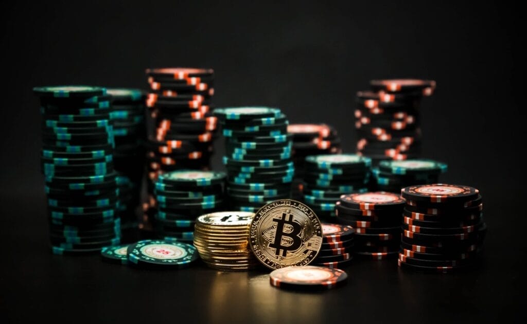 Bitcoin coins in front of stacks of poker chips