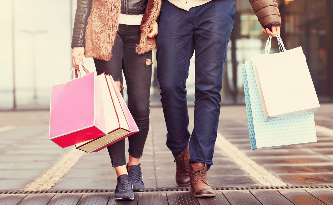 Midsection of couple with shopping bags