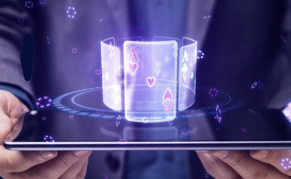Close up of businessman hands holding tablet with digital blue cards hologram on screen