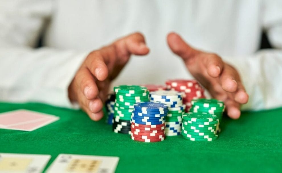 Closeup of hands pushing betting chips in casino
