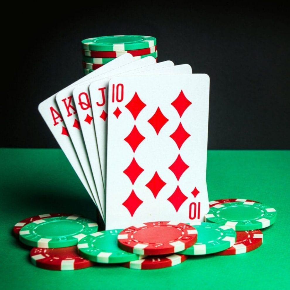 A royal flush leaning against a stack of poker chips.