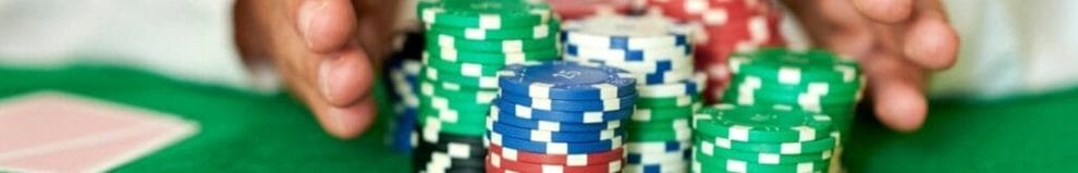 Closeup of hands pushing betting chips in casino