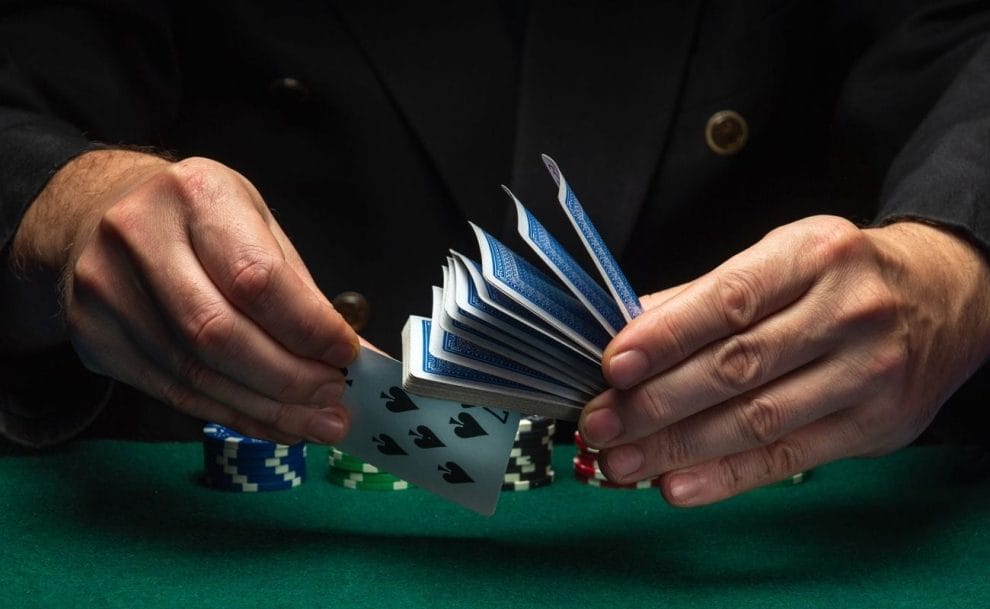 A dealer shuffles cards during a game of poker.