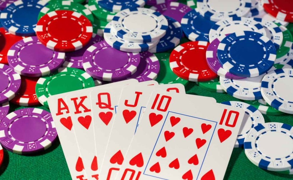Blackjack cards and colorful chips on a poker table.