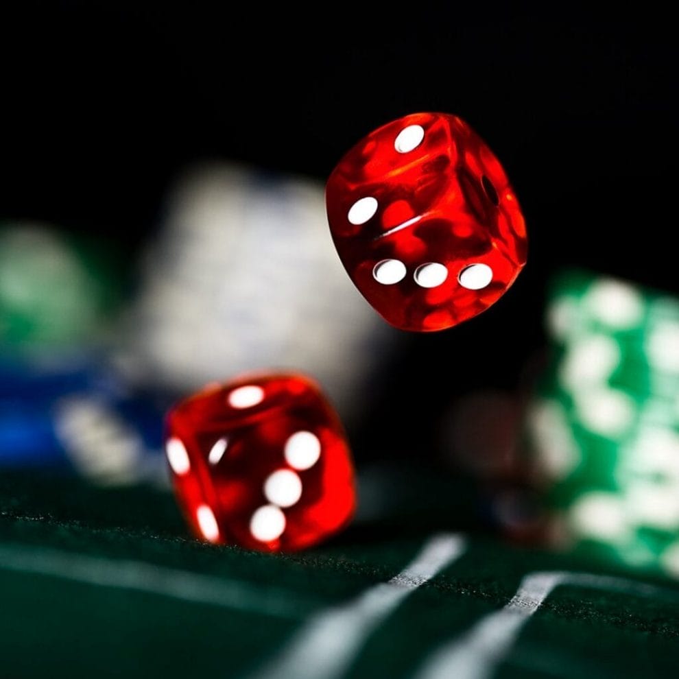 A close-up of dice landing on a casino table.
