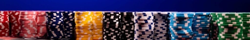 Stacks of casino chips lined up next to each other.