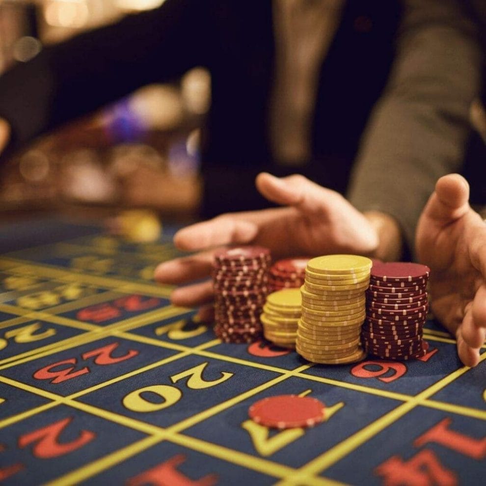 A player pushing all of their roulette betting chips onto the table.