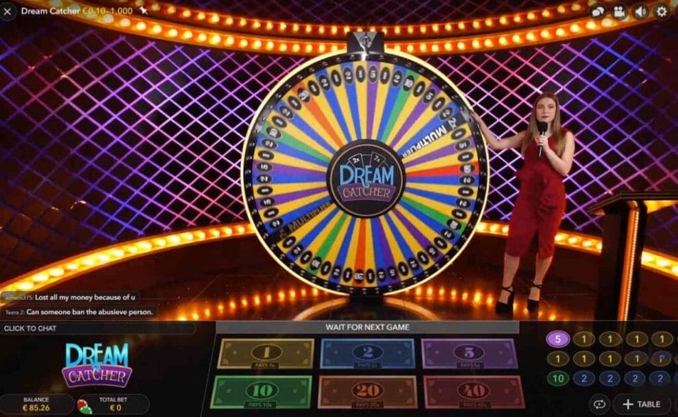 Presenter next to the spinning wheel in online casino game Dream Catcher by Evolution Gaming