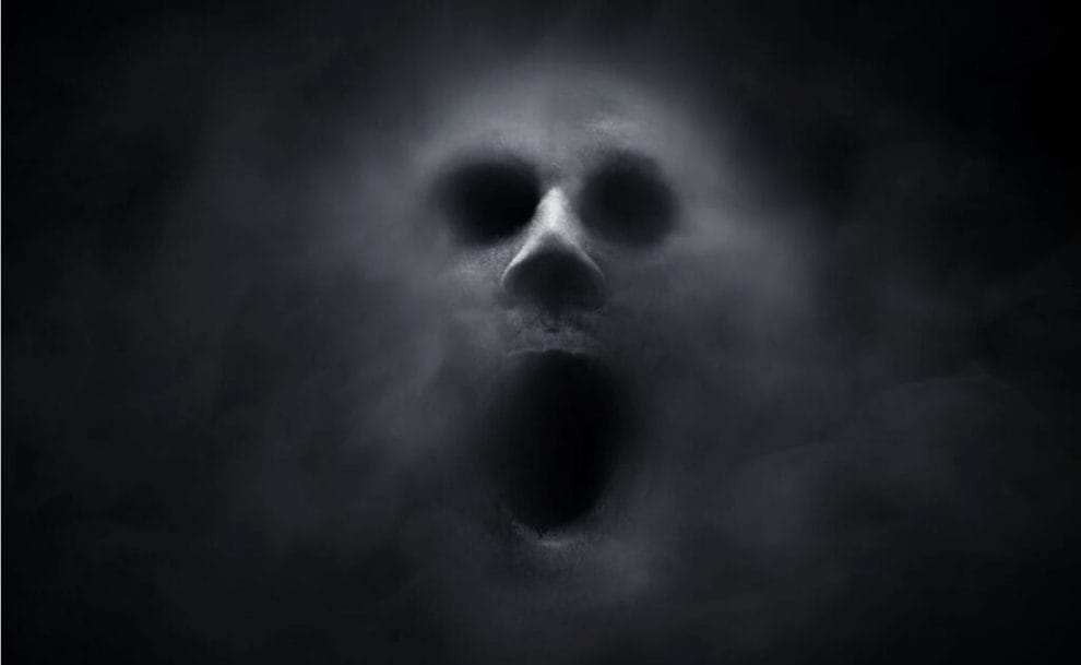 A ghostly face against a black background.