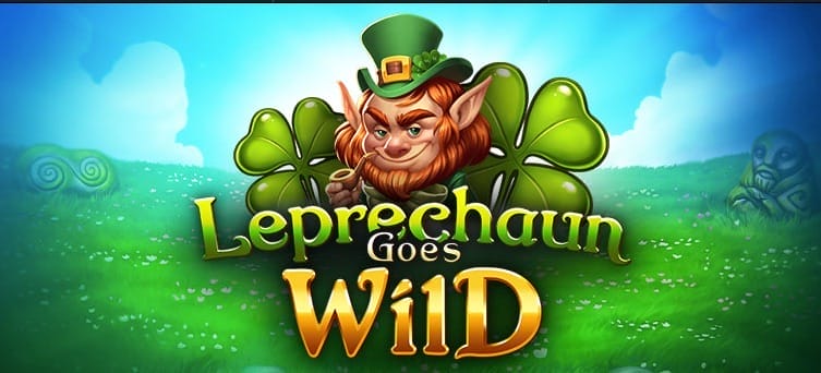 Leprechaun Goes Wild online slot loading screen, featuring a smug-looking cartoon leprechaun with a green and gold hat on his head and gold pipe in his mouth, surrounded by four leaf clovers in a grassy field against blue cloudy skies.