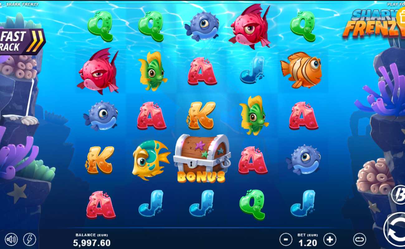 Shark Frenzy online slot with green, yellow, blue, orange and red fish alongside the A, K, Q, and J playing card symbols with purple and green coral on both sides of the reels.